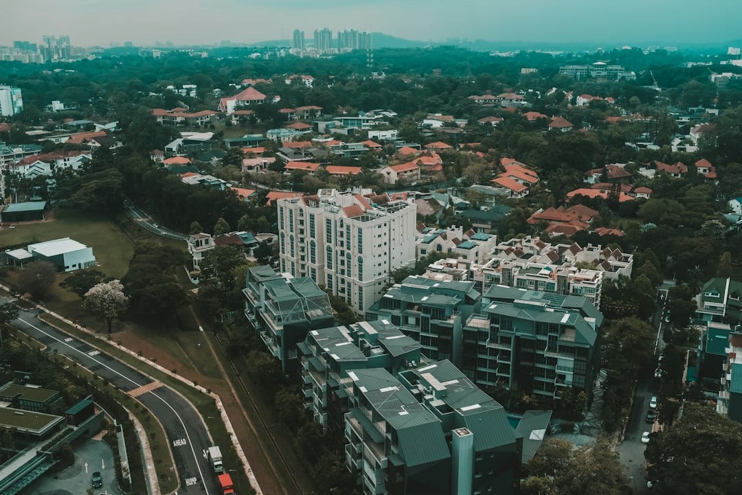 Cinematic editorial view of Kovan landed homes with stone and green accents